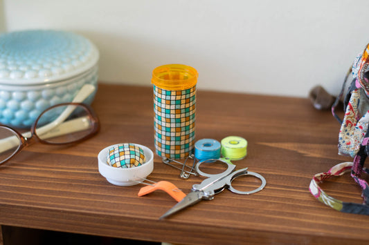 upcycled prescription bottle sewing kit — green and ochre tiles, 3.25" high, open with contents
