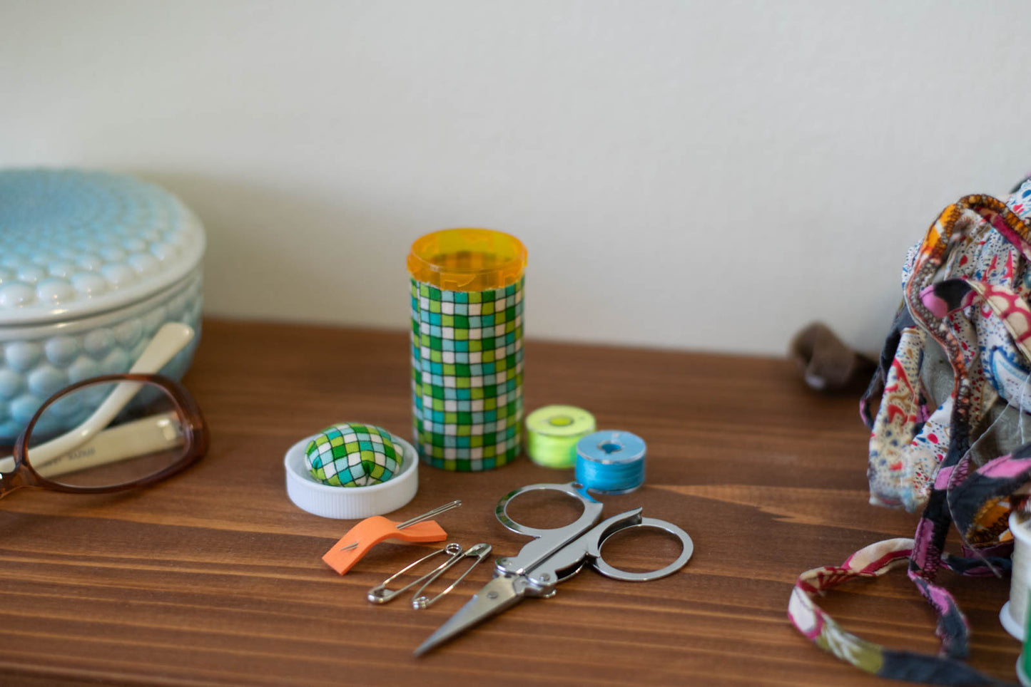 upcycled prescription bottle sewing kit — green tiles, 2.75" high, child proof lid, open with contents