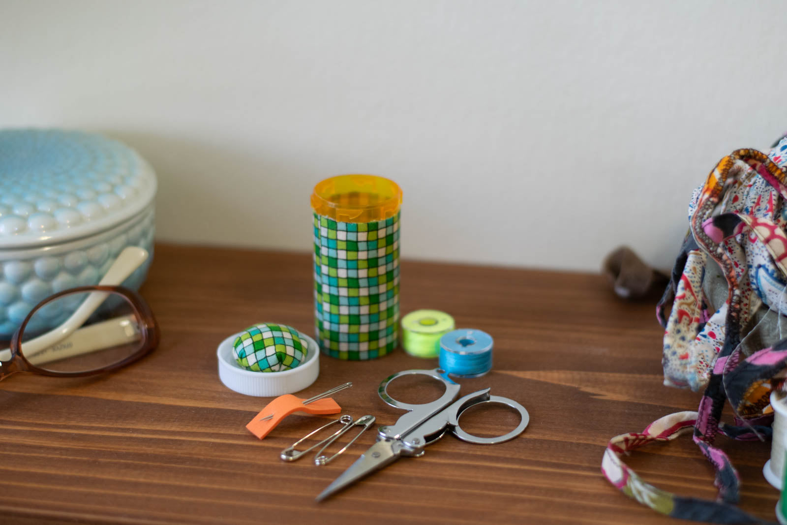 upcycled prescription bottle sewing kit — green tiles, 2.75" high, child proof lid, open with contents