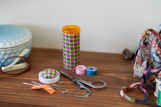 Upcycled Prescription Bottle Sewing Kit — Pink and Green Tiles, 1.5" diameter, open with contents