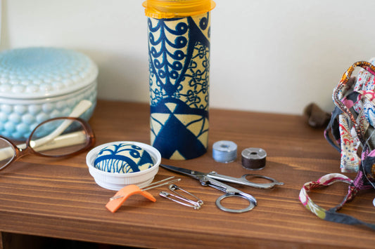 upcyclced prescription bottle sewing kit — blue African wax print, 5.75" high, open with contents