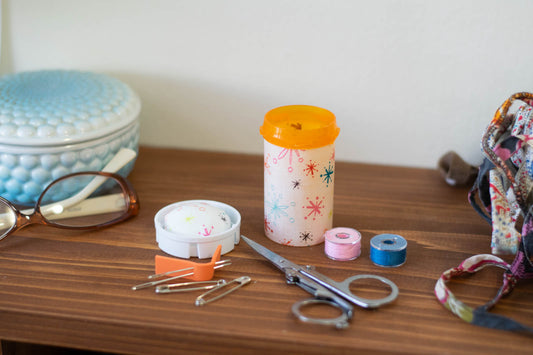 upcycled prescription bottle sewing kit — multi color sparkles on white, 3" high, open with contents
