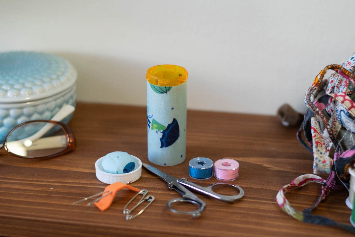 upcycled prescription bottle sewing kit — umbrella kids on blue, 3.25" high, open with contents
