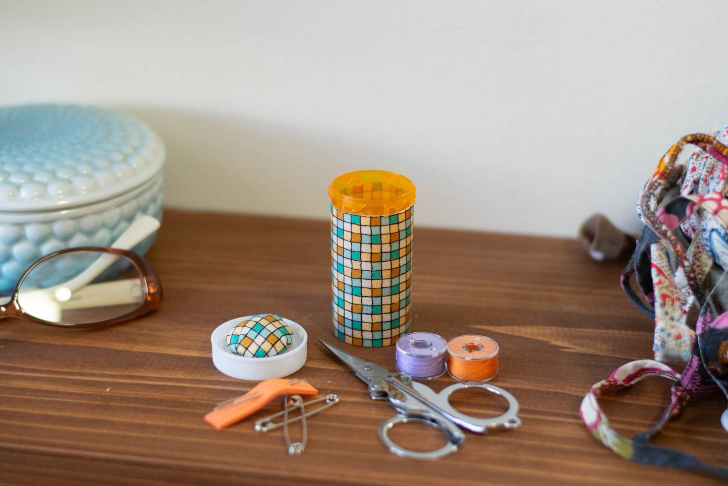 upcycled prescription bottle sewing kit — green and ochre tiles, 2.75" high, open with contents