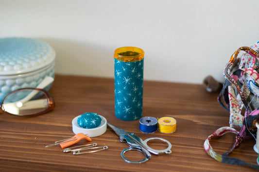 Upcycled Prescription Bottle Sewing Kit — White Sparkles on Teal, 1.5" diameter, open with contents