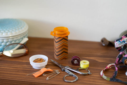 upcycled prescription bottle sewing kit — brown chevron pattern with dots, open with contents, 3.25" high