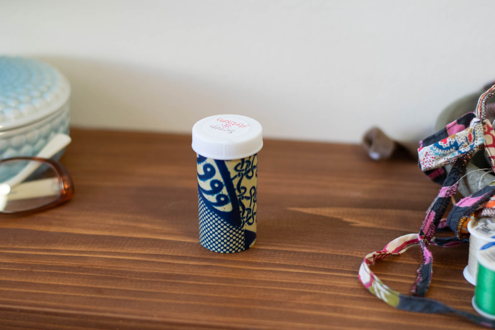 upcyclced prescription bottle sewing kit — blue African wax print, 2.75" high, closed