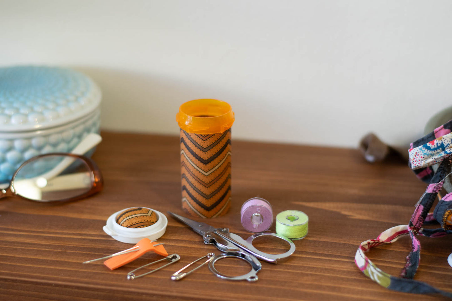 upcycled prescription bottle sewing kit — brown chevron pattern with dots, open with contents, 2.75" high