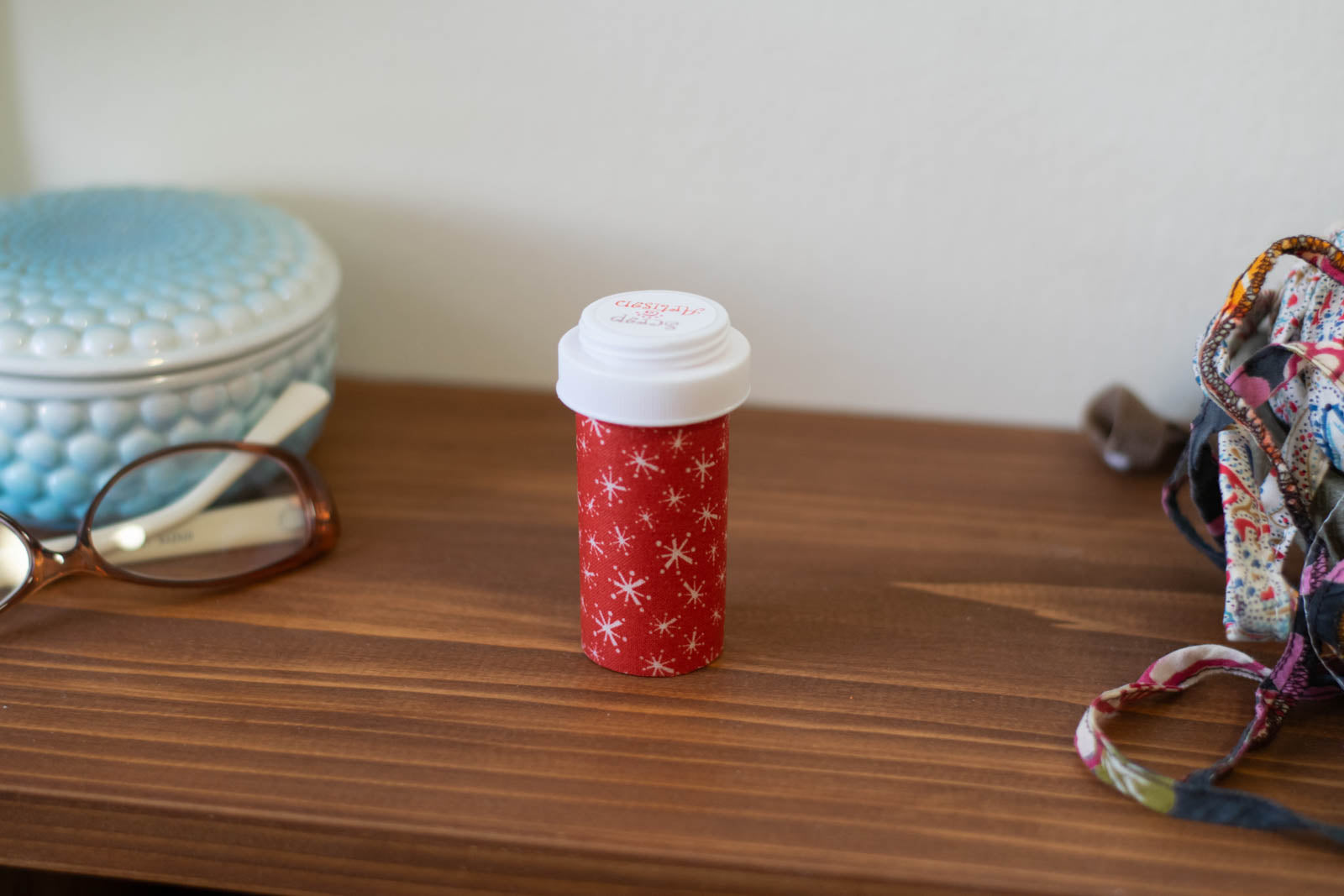 upcycled prescription bottle sewing kit — white sparkles on red, 3" high, closed