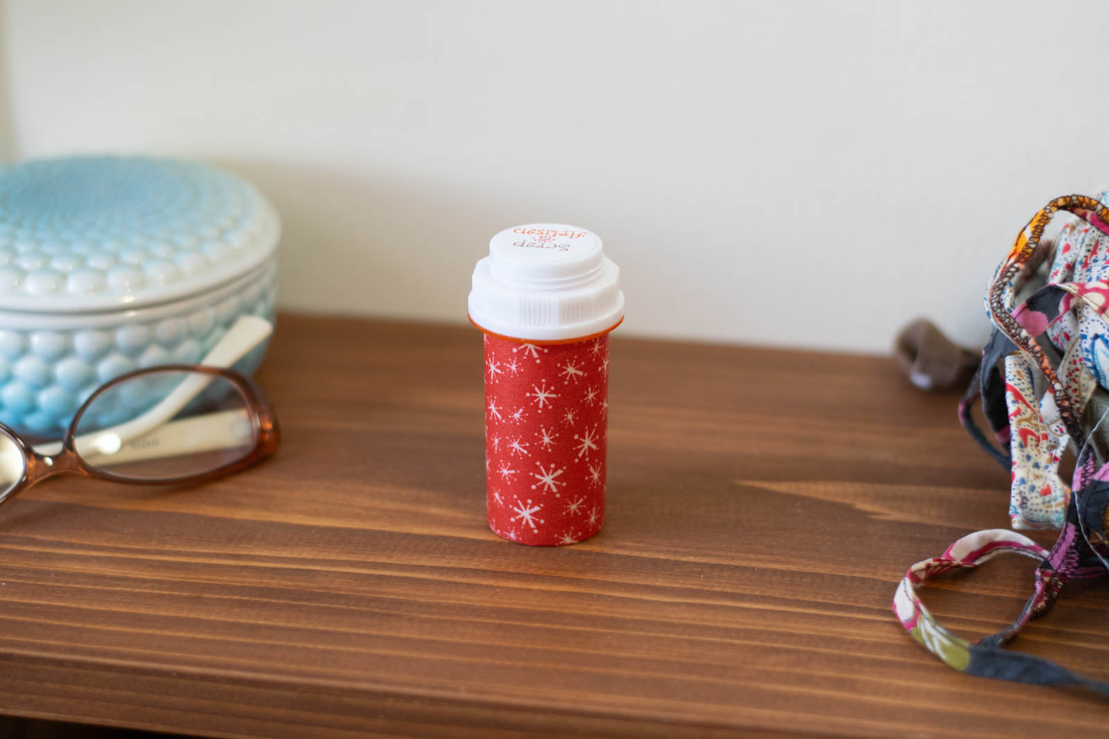 upcycled prescription bottle sewing kit — white sparkles on red, 3.25" high, closed